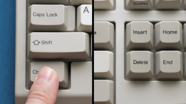 Male finger pushes CTRL + INSERT button on white keyboard. Slow motion and macro view