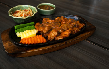Roast pork with sauce in a hot pan of Thailand