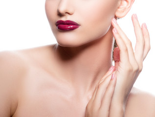 Fototapeta na wymiar Lips, neck and part of face of young Caucasian woman with brght glossy red lipstick, makeup and healthy clean skin. White background