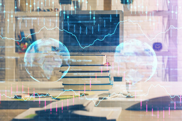 Financial graph colorful drawing and table with computer on background. Double exposure. Concept of international markets.