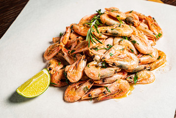 shrimps with lime dressing on the wooden background