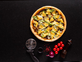 tasty pizza on the black background, top view