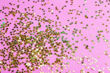 Gold glitter on a pink background. Celebration, party, birthday magic background. Creative minimal art concept