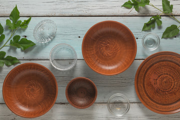 Clay and glassware on a blue plank background. Flat lay. Kitchen concept.