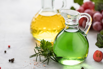 Grape seed oil in a glass bottle with a bunch of grapes on a white background. copy space.