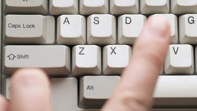 Male finger pushes CTRL + V button on white keyboard. Slow motion and macro view