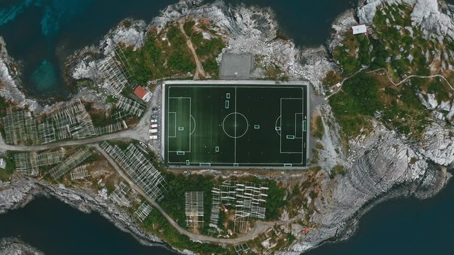 Football field on island aerial view sea in Norway Henningsvaer village travel in Lofoten islands top down famous landmarks drone scenery from above beautiful destinations