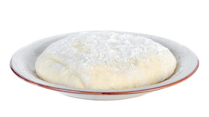 Raw dough lying on the plate on a white background.