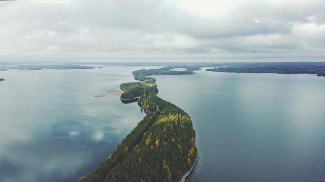 Aerial view lake and road island forest line landscape travel drone scenery from above in Finland scandinavian nature beautiful destinations