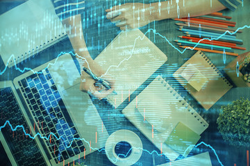Financial chart drawn over hands taking notes background. Concept of research. Double exposure