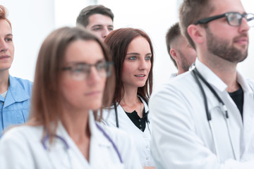 large group of doctors supported their success with applause