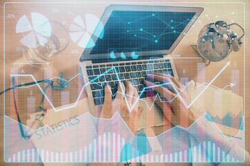 Multi exposure of forex graph with man working on computer on background. Concept of market analysis.