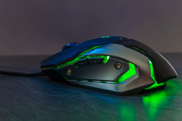 Green gaming mouse on stone texture table © Space Creator
