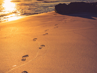 Sunset and footprints on beach