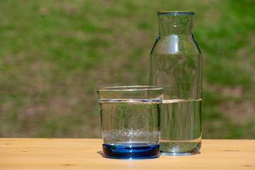 Pouring pure water in to the glass make spread of water crystal bubble with background nature