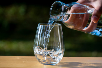 Pouring pure water in to the glass make spread of water crystal bubble with background nature
