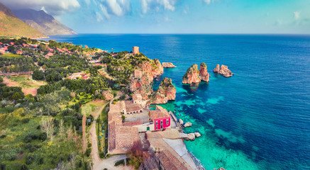 View from flying drone. Picturesque spring scene of Tonnara di Scopello. Colorful landscape of...