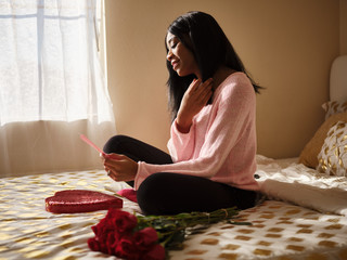 african american woman opening love letter on valentines day