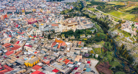 View from flying drone. Aerial morning cityscape of Gravina in Puglia tovn. Attractive spring landscape of Apulia, Italy, Europe. Top down view. Traveling concept background..