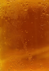 Close-up of a beer mug. Orange texture with bubbles