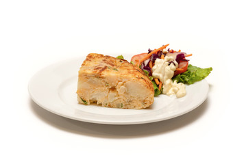 Close-up of a Spanish omelette with salad on an isolated white background