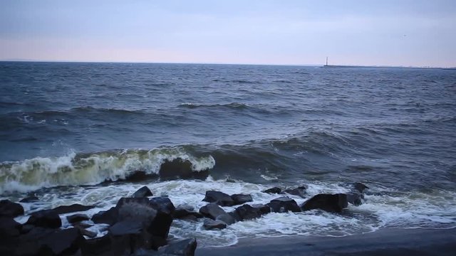 Storm on the Dnieper river in summer, cloudy sky, waves breaking on a rocky shore. City Svetlovodsk, Kirovograd region.
