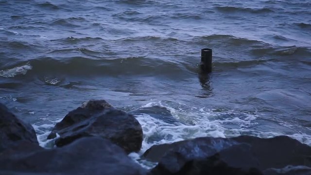 Storm on the Dnieper river in summer, cloudy sky, waves breaking on a rocky shore. City Svetlovodsk, Kirovograd region.