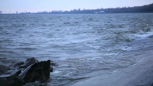 Storm on the Dnieper river in summer, cloudy sky, waves breaking on a rocky shore. City Svetlovodsk, Kirovograd region.