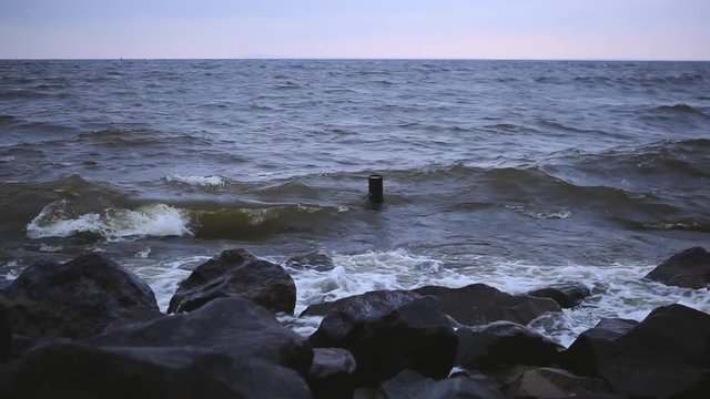 Storm on the Dnieper river in summer, cloudy sky, waves breaking on a rocky shore. City Svetlovodsk, Kirovograd region.
