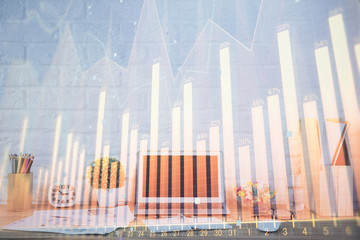 Stock market chart hologram drawn on personal computer background. Double exposure. Concept of investment.