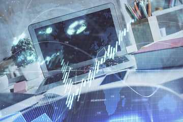 Financial market graph hologram and personal computer on background. Double exposure. Concept of forex.