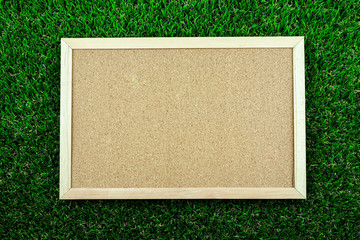 Brown picture frame on green grass