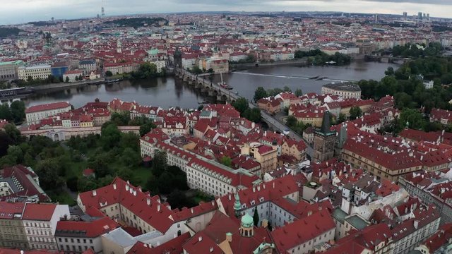 Wide opening Panorama Aerial shot of Prague - Flying from Lesser Town towards Vltava River and Charles Bridge, Czech Republic