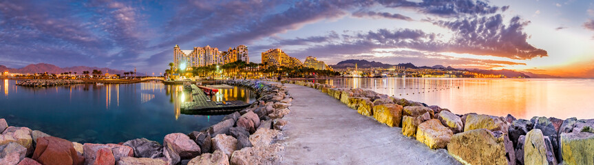 Evening panoramic view from public walking pier on central beach and promenade of Eilat - famous...