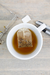 Cup of tea on a desk from above