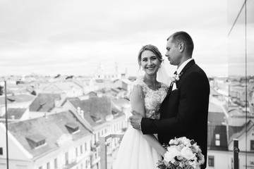 Wedding fashion caucasian couple outdoors in old city background. Beauty, wedding, fashion concept