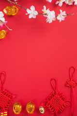 Fototapeta na wymiar Design concept of Chinese lunar new year - Beautiful Chinese knot with plum blossom isolated on red background, flat lay, top view, overhead layout.