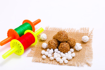 Indian festival makar sankranti concept, Kite String with Sesame seed ball or til ke laddo