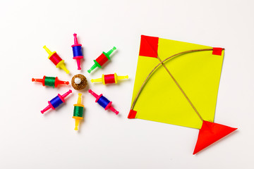 Indian festival makar sankranti concept, sesame seed ball or til ke laddo and tilgul with colorful paper kite