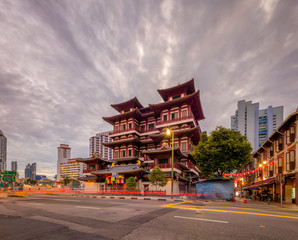 Fototapeta na wymiar Buddha's Tooth Relic Temple, Singapore - Aug 2019 - The famous pagoda during blue hour sunset dramatic afternoon