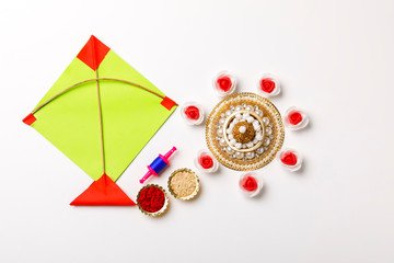 Indian festival makar sankranti concept, sesame seed ball or til ke laddo and tilgul with colorful paper kite