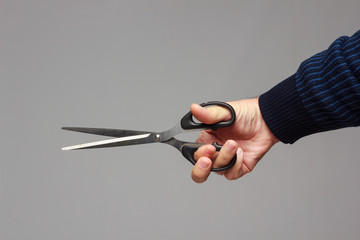 Scissors in a person's hand