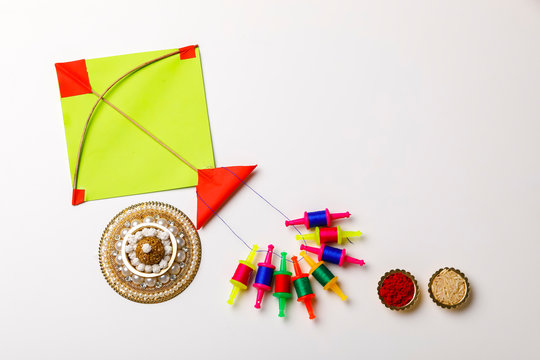 Indian festival makar sankranti concept, sesame seed ball or til ke laddo and tilgul with colorful paper kite
