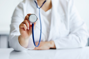 Female doctor with stethoscope in medical office