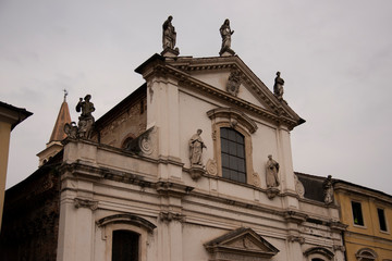 Fototapeta na wymiar Facade of the church of Santa Maria in Foro called Dei Servi in Vicenza, Italy. Made in 1710 with stone moldings and capitals, with nine statues made by Angelo and Orazio Marinali and Giovanni Calvi.