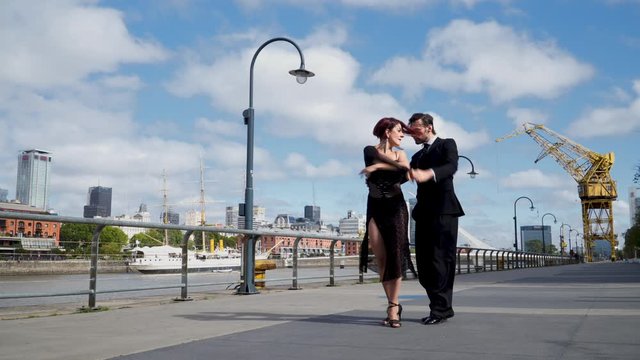 A couple of good looking tango dancers dancing in iconic place of Buenos Aires