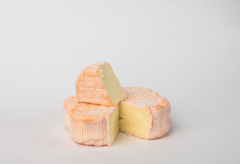 Camembert cheese isolated on a light background