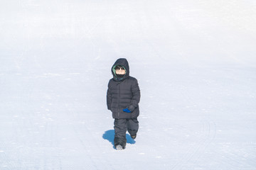 Fototapeta na wymiar An Asian boy is playing snow in winter.
