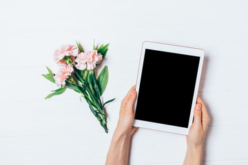 Woman's hands holding tablet computer