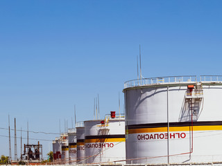 Fototapeta premium Tank the vertical steel. Capacities for storage of oil products. Caption: flammable.